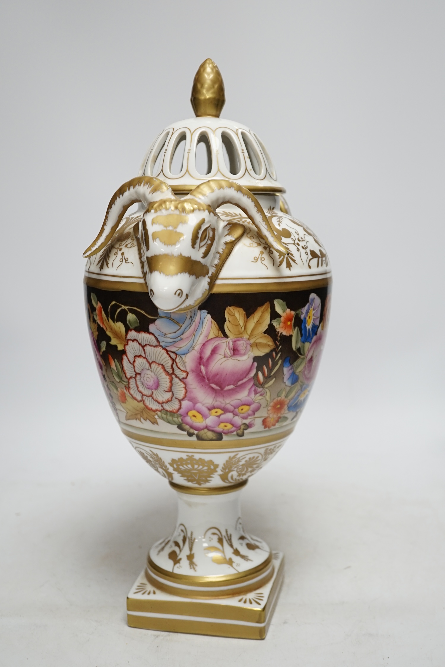 A late 20th century ‘rams head’ porcelain urn and cover, 38cm